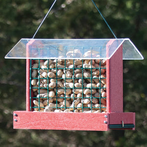 Going Green Peanut or Cake Feeder, Red, filled with peanuts, featuring mesh sides for easy bird access and a protective roof.