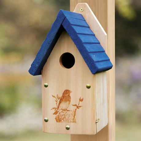 Garden Bluebird House with a blue roof, mounted on a post, features a laser-etched bluebird design and a side panel for easy cleaning.