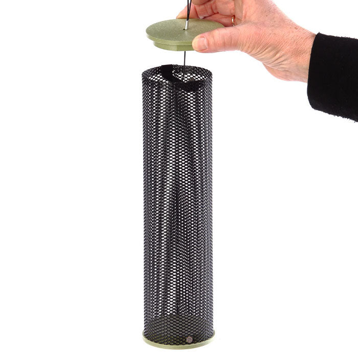 Hand holding Green Nyjer Mesh Tube Feeder with a black mesh and green top. Designed for finches, holds 1.25 lbs of Nyjer seed.