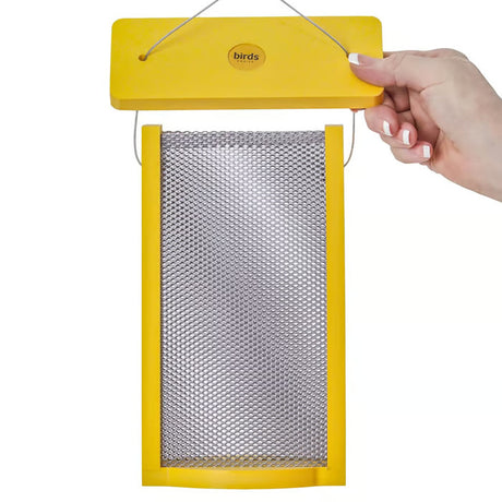 Hand holding Tall Finch Bird Feeder in Yellow Recycled Plastic with steel mesh for Nyjer seeds.