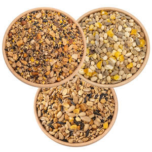 3 Bowls of birdseed from a birds eye view, specifically:  Super No-Waste Blend, Four Seasons No-Waste, and Fancy Finch Mix