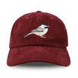 Burgundy corduroy baseball cap with embroidered Black-capped Chickadee, featuring an unstructured 6-panel crown, curved bill, and adjustable fabric strap.