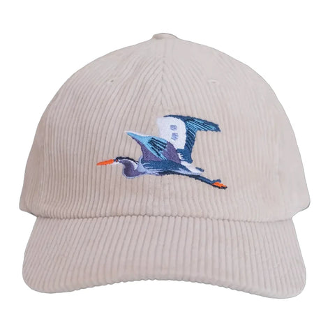 Great Blue Heron Corduroy Hat, Ivory: Light-beige six-panel cap with a blue, purple, and white heron embroidery, orange beak and feet, adjustable back.