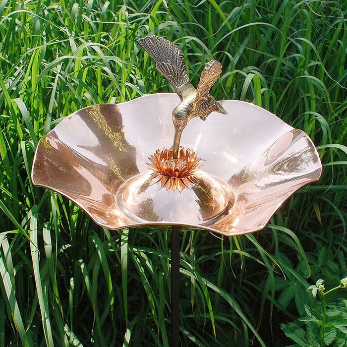 Hummingbird Bird Bath with Stake featuring a hummingbird statue sipping from a flower-shaped basin, perfect for garden decoration and attracting birds.