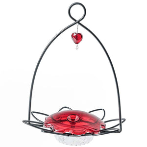 Hummingbird Flower Feeder: Metal frame shaped like a flower with a red plastic gem, clear dish for nectar, and metal hanging loop.