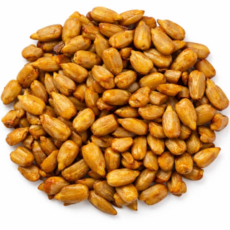 Pile of spicy hot whole sunflower hearts bird seed on a white background