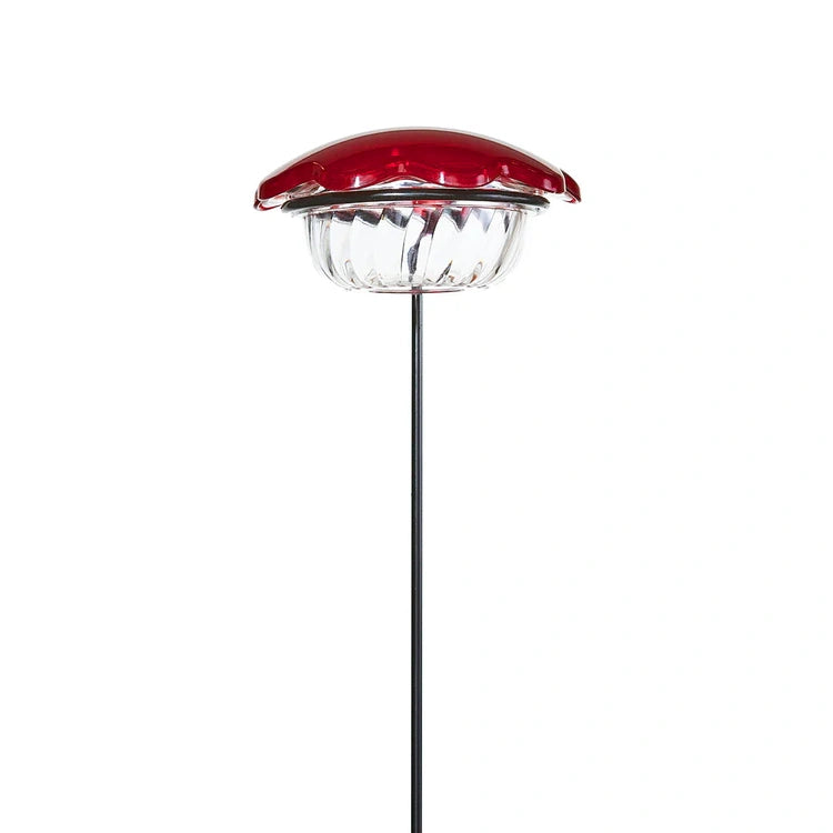 Hummingbird Plant Stick with a solar-powered red flower cap, clear lens, and black metal stake, designed to attract hummingbirds with a 3 oz. feeder capacity.