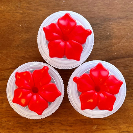 HUM-Buttons™ Mini Handheld Hummingbird Feeders, Set of 3, featuring red flower designs on white plastic containers.