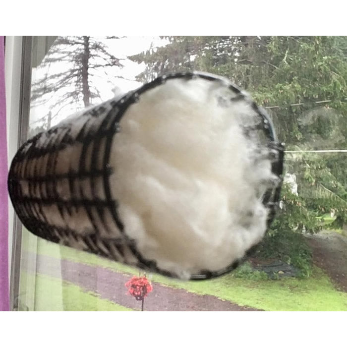 Basket with soft, white cotton nesting material for hummingbirds, featuring a suction cup and clip for easy hanging.