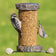 Sea Stones Lifetime Seed Cylinder Bird Feeder with two birds feeding. Handmade from reclaimed granite, featuring durable, unique design with woodpecker and nuthatch visible.