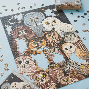 Jigsaw puzzle with illustrated owls on a blue background