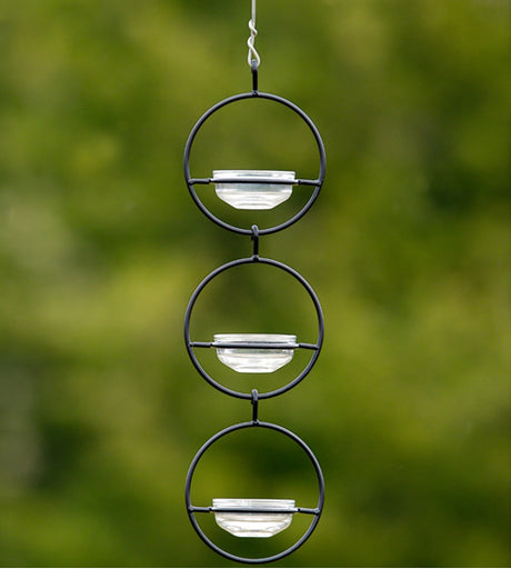 Triple Sphere Hanging Dish Feeder with three metal spheres and glass dish containers, mounted on a wire, ideal for offering fruits, seeds, and mealworms to birds.