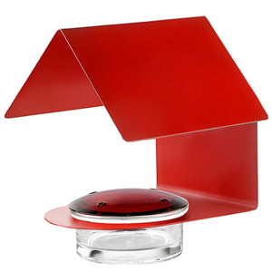 The Cottage Hummingbird Feeder Red features a glass dish with a red roof, steel frame, and four feeding ports, ideal for attracting hummingbirds.