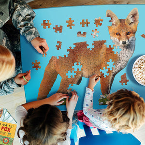 Group playing with the I Am Lil' Fox 100 pc. Puzzle, featuring large, animal-shaped pieces and an educational booklet.