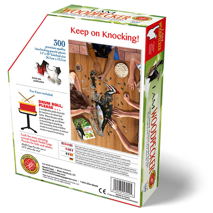 I Am Woodpecker 300 pc. Puzzle box with children placing puzzle pieces on the floor, includes educational Madd Capp Fun Facts booklet and full puzzle image.