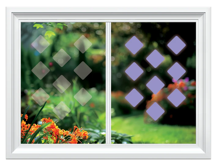 Window with decorative film showing a geometric pattern with purple shapes, set against a blurred garden background.