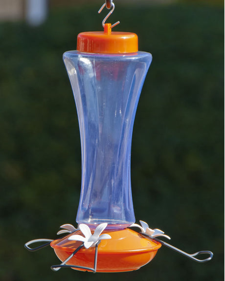 Trumpet Oriole Feeder with wide perches, clear plastic reservoir, orange top and bottom, three white metal flower-shaped feeding ports, and 20 oz. capacity.