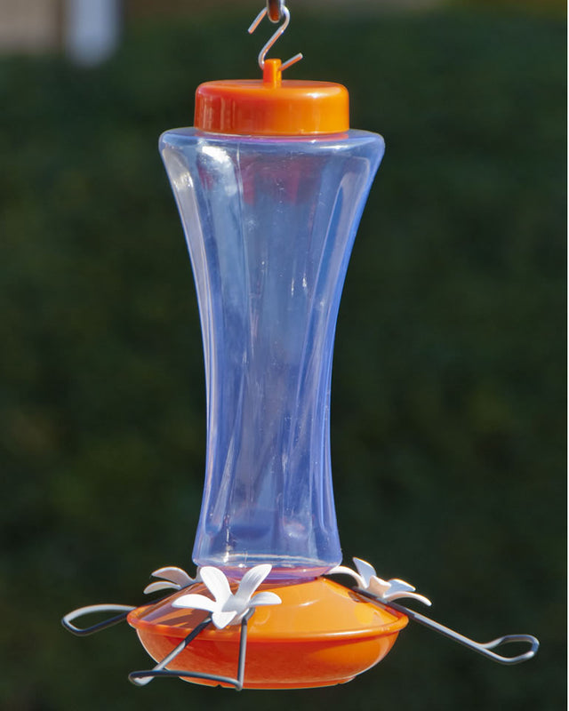 Trumpet Oriole Feeder with wide perches, clear plastic reservoir, orange top and bottom, three white metal flower-shaped feeding ports, and 20 oz. capacity.