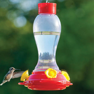 18 oz. Plastic Hummingbird Feeder with Ant Moat featuring a clear reservoir and yellow flower-shaped feeding ports, with a hummingbird flying nearby.