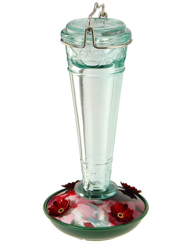 8 oz. Torchiere Glass Hummingbird Feeder with floral scrollwork, see-through bottle, and red flower-shaped feeding ports, designed for easy refills and cleaning.