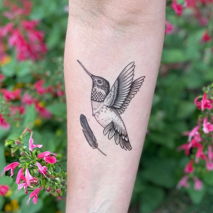 Hummingbird Temporary Tattoo: Detailed hand-drawn design featuring a 4-inch hummingbird and a 2-inch feather, symbolizing renewal and joy.