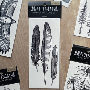 Feather Finds Temporary Tattoo: A set of nature-inspired temporary tattoos depicting three intricate feather designs. Water-resistant, nontoxic, and vegan, lasting 2-5 days.