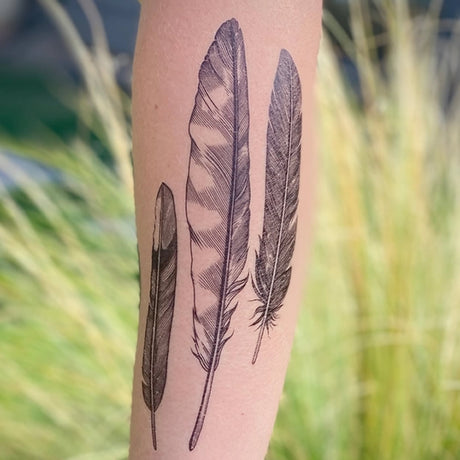 Feather Finds Temporary Tattoo featuring detailed feather designs on a person's arm. Temporary, nature-inspired tattoo by Allison Wilcoxen, water-resistant, skin-safe, and lasts 2-5 days.