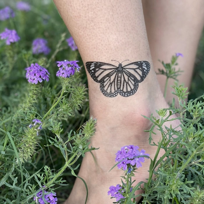 Monarch Butterfly Temporary Tattoo on an ankle, featuring detailed black lines and a wingspan of over 3-1/2 inches.