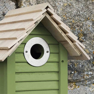 New England Nest Box: A green birdhouse with a round hole, real shingle roofs, and lapboard sides, ideal for small birds.