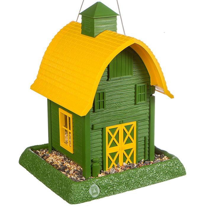 Green Barn Bird Feeder with clear window panes, a removable tray, and a wire hanger for easy refilling and cleaning. Durable, barn-style design for outdoor use.