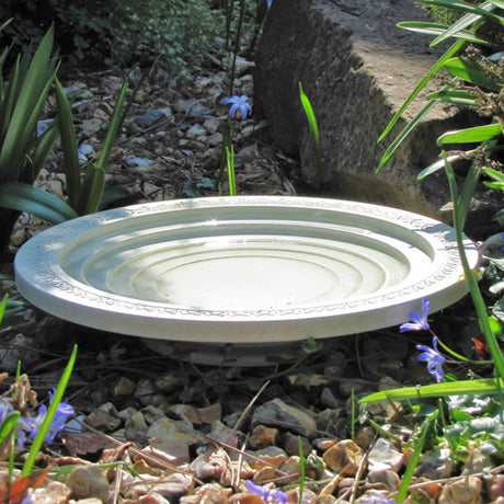 Nature Oasis Bird Bath in a garden setting. Features shallow steps for easy access by birds and insects, made from recycled plastic and bamboo fibers.