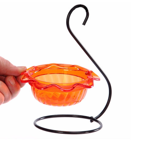 Hand holding an Oriole Single Cup Feeder with a wavy-edged orange dish for feeding orioles.