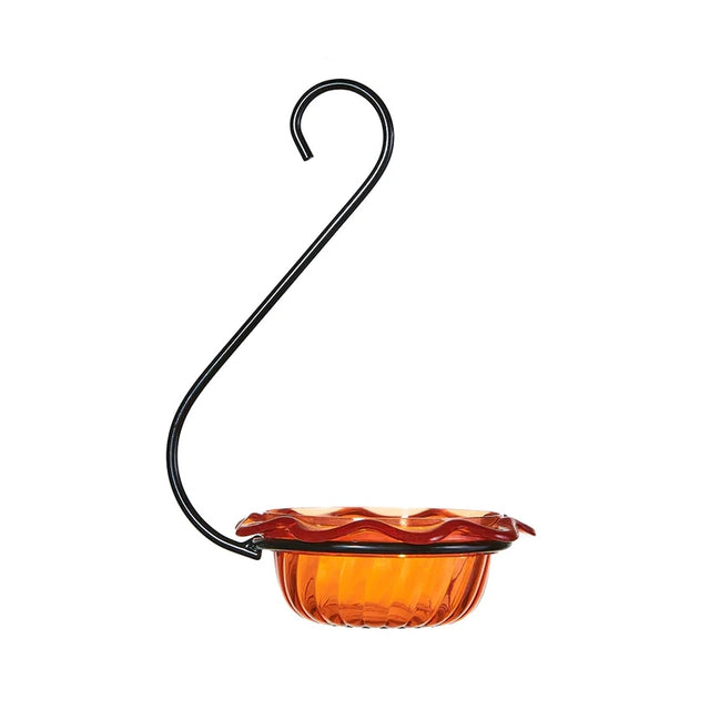 Orange glass hummingbird feeder with black metal hook on a white background