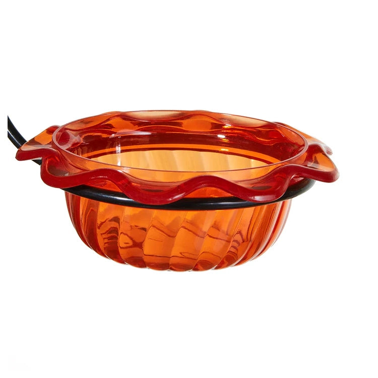 Orange glass bowl with wavy design on a white background