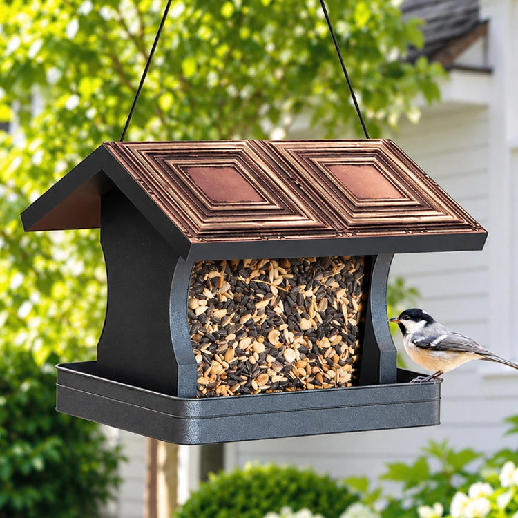 Modern Farmhouse Vintage Wood with Tin Roof Hopper Feeder showcasing a bird perched on it. Feeder design supports various birds and holds up to 4 lbs of seed.