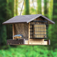 Going Green® Contemporary Deluxe Ranch Feeder with Suet Feeders, featuring dual-feed design with seed tray and suet cage, attracts diverse birds in a forested setting.
