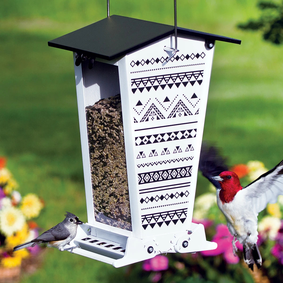Snack Shack Nordic Habitat Squirrel-Resistant Feeder with white metal, black trim, and two birds feeding. Features squirrel-proof design and weight-activated perches.