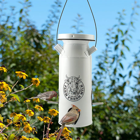 Milkhouse Milk Can Seed Feeder with Farm Fresh Milk logo, features perches for birds, surrounded by black-eyed Susans, enhancing garden attractiveness.