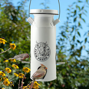 Milkhouse Milk Can Seed Feeder with bird perched, featuring four feeding ports and a locking lid for weather protection, designed for easy bird-watching and feeding.