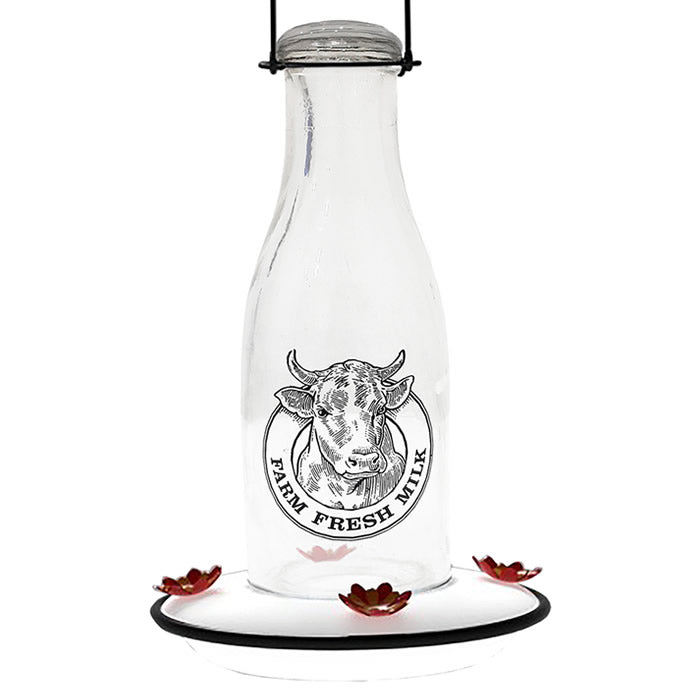 Milkhouse 24 Ounce Glass Hummingbird Feeder featuring a vintage milk can design with a cow logo, four flower-shaped feeding ports, and a sturdy attached hanger.