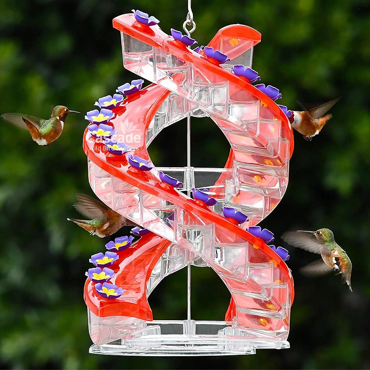 Spiral-shaped hummingbird feeder with red and clear design, surrounded by flying hummingbirds.