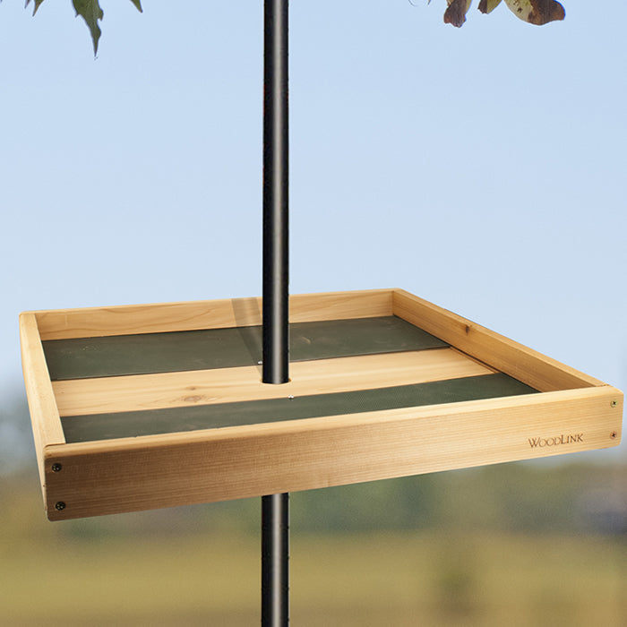 Pole Seed Tray with Mounting Bracket, featuring a wooden platform feeder attached to a black pole, designed to attract birds and minimize seed waste.