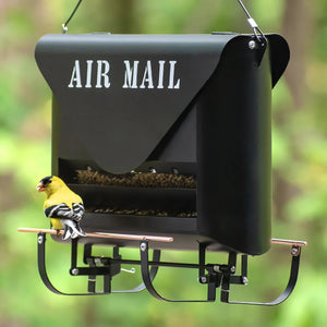 Absolute Squirrel-Resistant Air Mail Feeder shaped like a mailbox, filled with seed, featuring a perched American goldfinch on its adjustable perch.