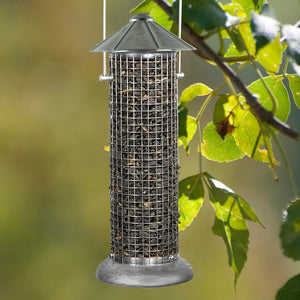 Rustic Farmhouse Silo Sunflower Seed Feeder hanging from a tree, featuring a vintage mesh design for clinging birds to feed on sunflower seeds.