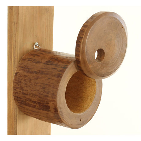 Pivot Bird Home: Artisan-crafted wooden birdhouse with holes for small songbirds, featuring a pivoting front panel secured by a metal pin for easy cleaning.