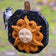 Sun Face Seed Wreath with sunflower and millet seeds, featuring a Downy Woodpecker pecking, designed to attract birds, includes a natural jute hanger.