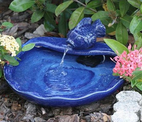 Ceramic Koi Solar Fountain with a koi water feature, flowing water from the koi's mouth into the bowl, powered by a separate solar panel.