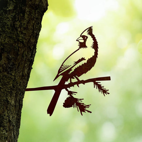 Metal Cardinal sculpture perched on a tree branch, crafted from durable Corten Steel, designed to enhance garden charm with intricate, precision-cut details.