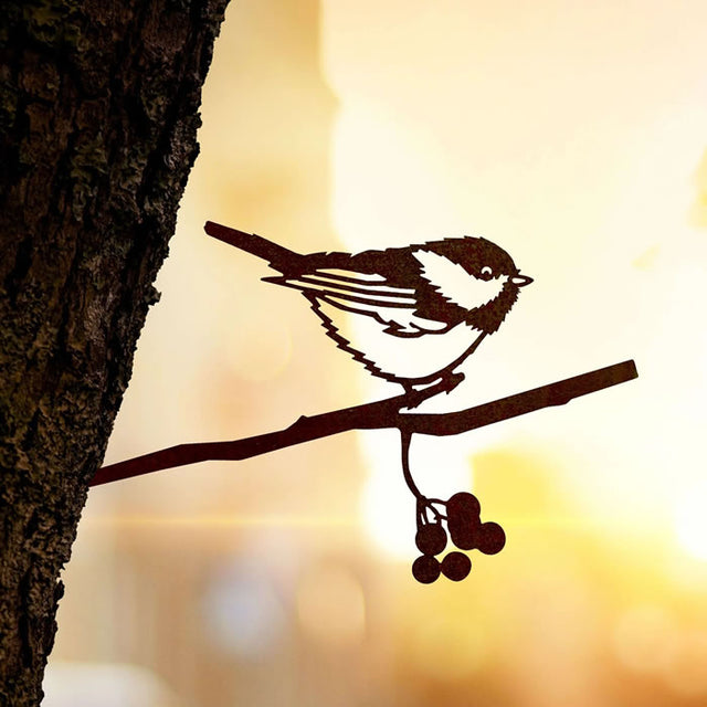 Metal Chickadee sculpture perched on a branch, crafted from Corten Steel, designed for easy installation in gardens.