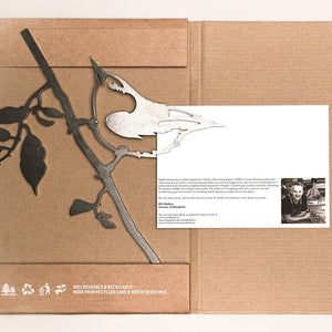 Metal Nuthatch sculpture in a cardboard box with a card, showcasing a bird on a branch, made from durable Corten Steel for garden decoration.